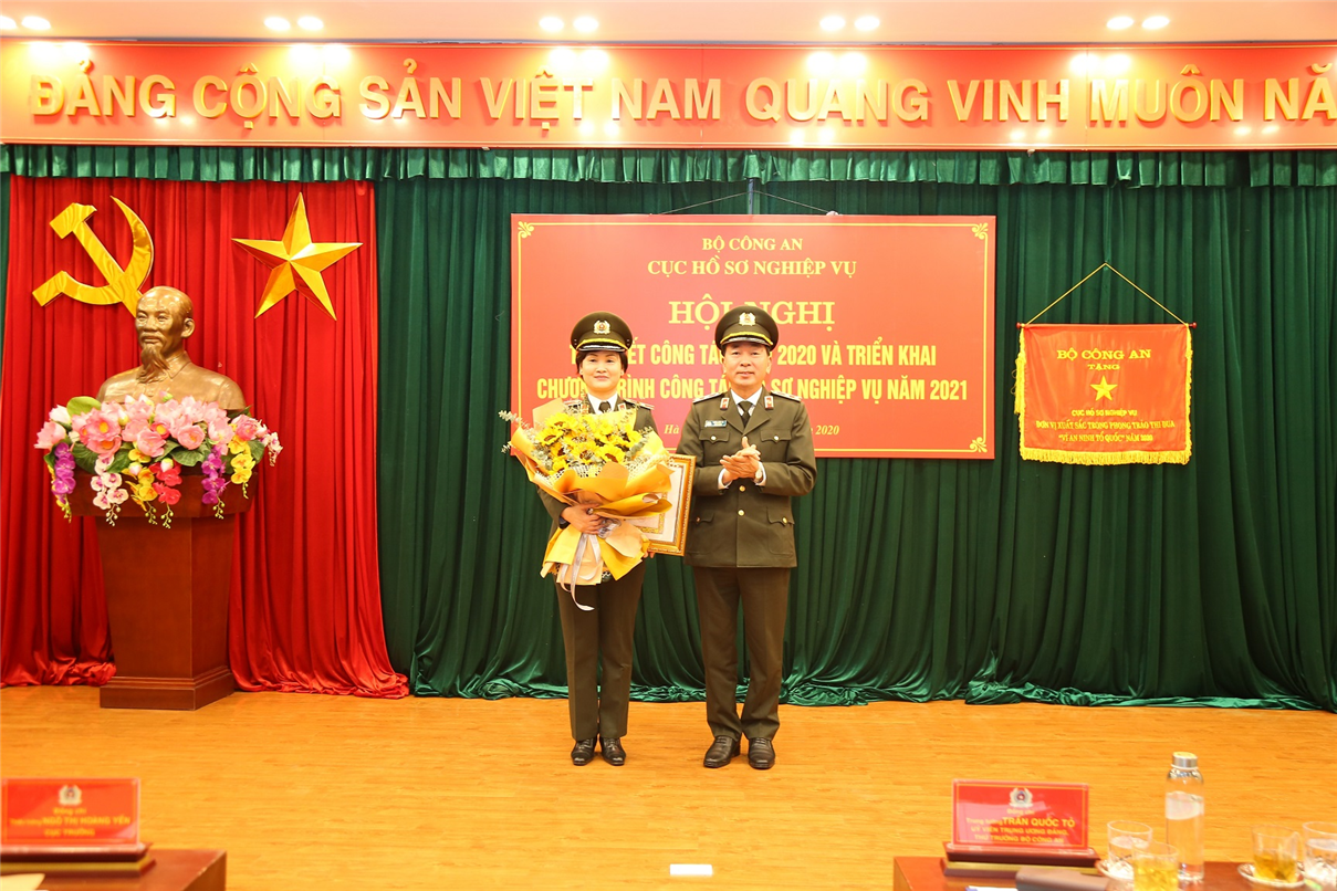 Thứ trưởng Trần Quốc Tỏ trao tăng Huy hiệu 30 năm tuổi Đảng cho Thiếu tướng Ngô Thị Hoàng Yến.