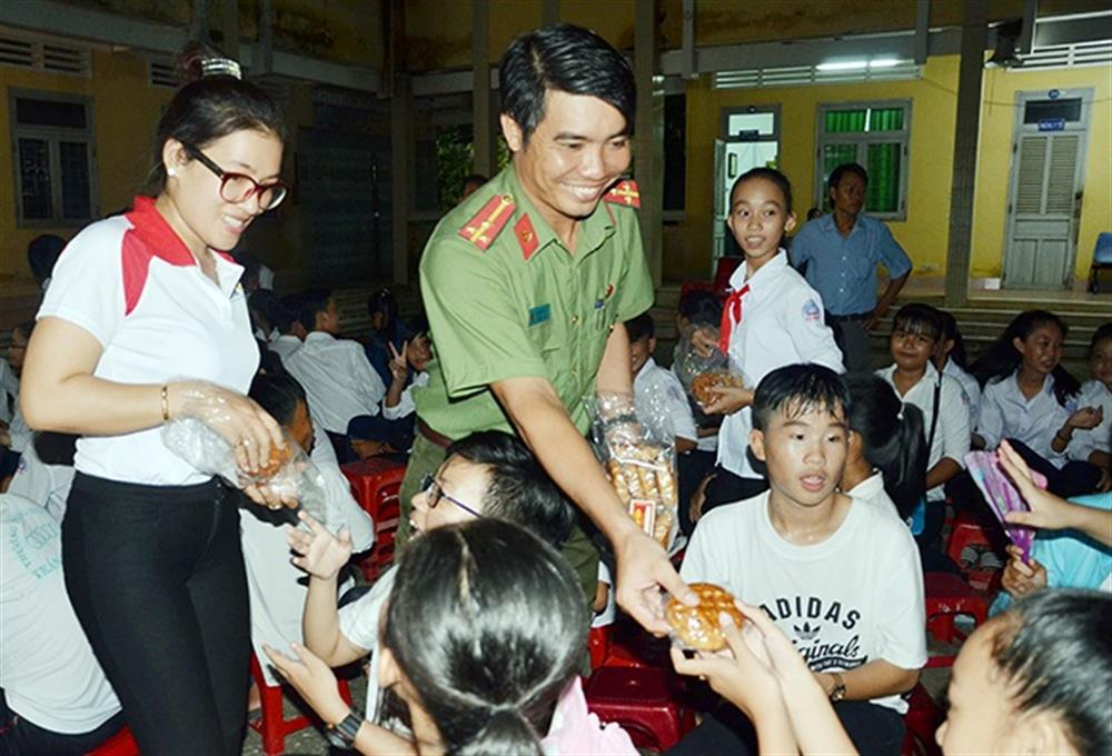 Thượng úy Nguyễn Bé Xuân tham gia vận động, tặng quà cho học sinh, người nghèo.