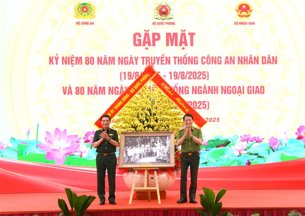 Bộ trưởng Phan Văn Giang trao lẵng hoa của Quân ủy Trung ương, Bộ Quốc phòng và bức ảnh tặng Đảng ủy Công an Trung ương, Bộ Công an.