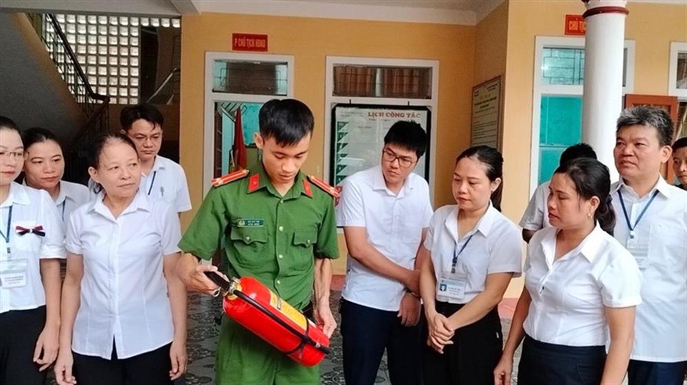 Công an hướng dẫn cán bộ, công chức phường Nam Hồng sử dụng bình chữa cháy.