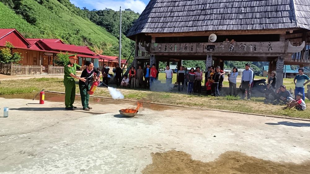 Thượng úy Hà Văn Tuấn hướng dẫn người dân sử dụng bình chữa cháy.
