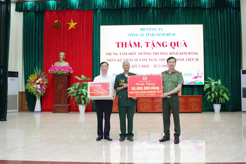 Thừa ủy quyền, Đại tá Lê Văn Tuấn trao số tiền 50 triệu đồng của Bộ Công an tặng Trung tâm điều dưỡng Thương binh Kim Bảng.